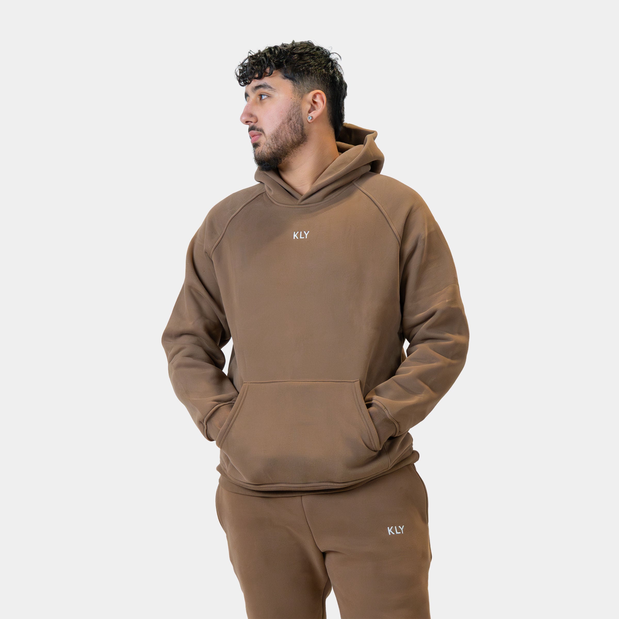 Male model in the KLY Original Hoodie in Mocha, three-quarter view