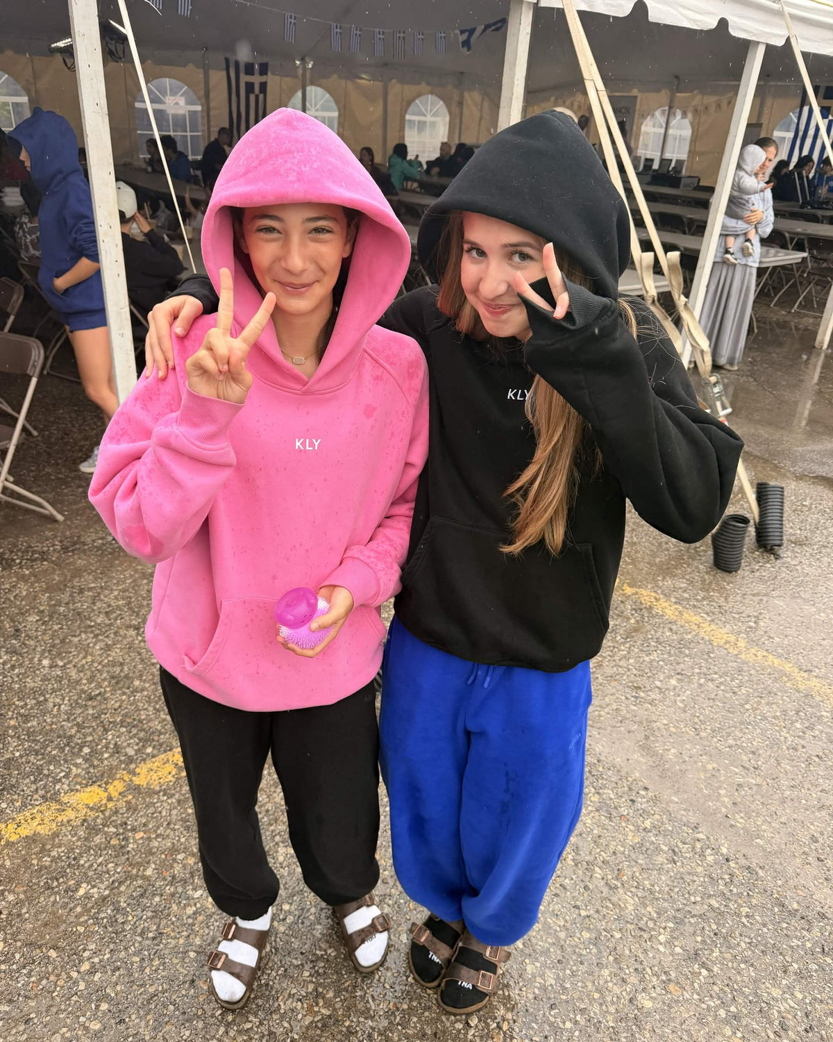 Customer wearing the KLY hoodie in Pink and Black